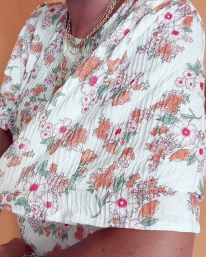 Bluse mit Rundhalsausschnitt und Blumenmuster, kurzärmlig