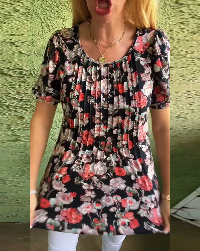 Blusa floreale plissettata con maniche a sbuffo e scollo tondo