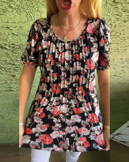 Blusa floreale plissettata con maniche a sbuffo e scollo tondo
