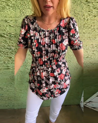 Blusa floreale plissettata con maniche a sbuffo e scollo tondo
