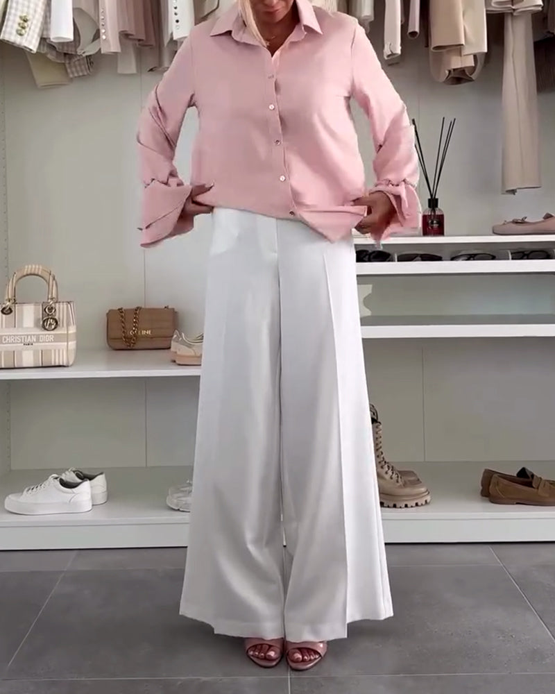 Camicia tinta unita con maniche a campana e bottoni sul risvolto