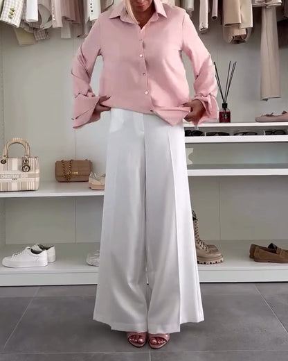 Camicia tinta unita con maniche a campana e bottoni sul risvolto