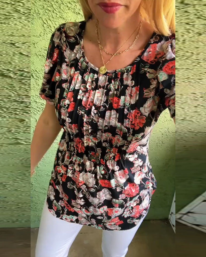 Blusa floreale plissettata con maniche a sbuffo e scollo tondo