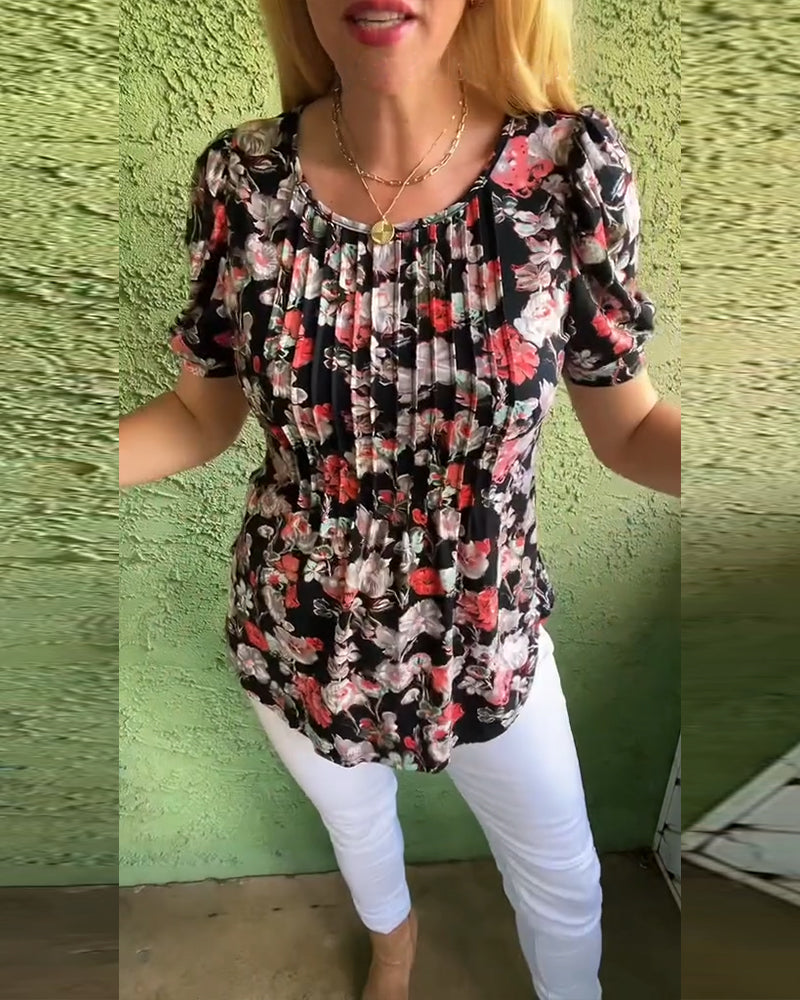 Blusa floreale plissettata con maniche a sbuffo e scollo tondo